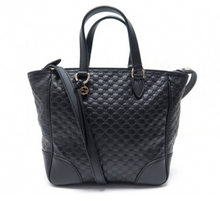 Load image into Gallery viewer, This Gucci GG Logo Microguccissima Black handbag is so cute and perfect for everyday. This classic black is sure to become a staple to your wardrobe.  The inside has two credit card slots and one zip pocket. This Gucci handbag also includes a Gucci tassel along with a removable/ adjustable strap. Includes authenticity cards and Gucci dust bag. Made in Italy. 