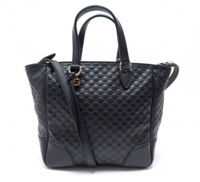 This Gucci GG Logo Microguccissima Black handbag is so cute and perfect for everyday. This classic black is sure to become a staple to your wardrobe.  The inside has two credit card slots and one zip pocket. This Gucci handbag also includes a Gucci tassel along with a removable/ adjustable strap. Includes authenticity cards and Gucci dust bag. Made in Italy. 