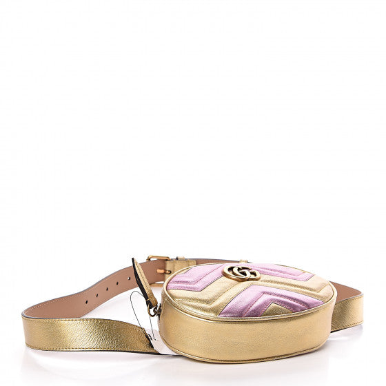 This belt bag is crafted of smooth gold and pink chevron stitched leather. This bag is an oval shape with a leather belt that can be worn as a belt bag. The belt bag features an aged gold GG logo on the front and a heart stitched shape on the back of the bag with an adjustable belt closure. The handbag opens to a blue satin interior with a patch pocket. This compact, yet spacious belt bag is perfect for any time of the day; whether it be for casual or formal wear, from Gucci!