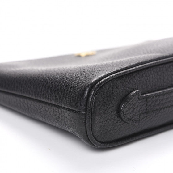 The Gucci Calfskin GG Marmont Pouch in Black is crafted of lovely textured calfskin leather in black. This bag features a top zipper that opens to a beige fabric interior with a zipper pocket and card slots on one side and a single pouch pocket on the opposite.