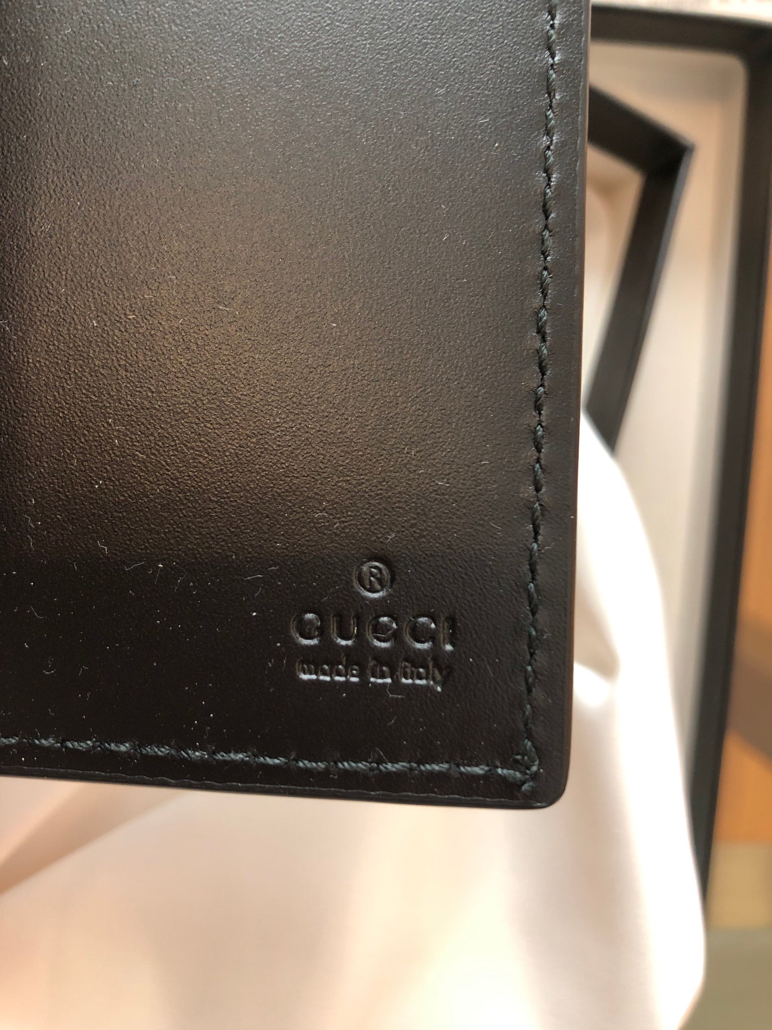 GG Embossed Passport Holder in Black - Gucci