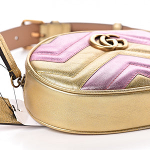 This belt bag is crafted of smooth gold and pink chevron stitched leather. This bag is an oval shape with a leather belt that can be worn as a belt bag. The belt bag features an aged gold GG logo on the front and a heart stitched shape on the back of the bag with an adjustable belt closure. The handbag opens to a blue satin interior with a patch pocket. This compact, yet spacious belt bag is perfect for any time of the day; whether it be for casual or formal wear, from Gucci!