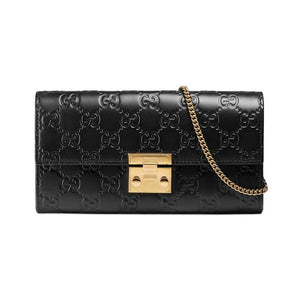 The Gucci Padlock Continental Wallet on a Chain in Black is the chic, everyday piece of luxury you desire. Black leather is embossed int eh signature interlocking GG pattern in a continental style wallet. The top flap is securely fastened with a padlock clasp in a polished gold-tone. A small removable strap allows this piece to effortlessly transition between wallet, clutch, and handbag. The interior includes  5 bill slots, 12 credit card slots, and 1 zippered compartment to keep you organized all day long.
