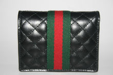 Load image into Gallery viewer, The Gucci GG Marmont Web Quilted Card Case Wallet in Black is a mini snap wallet in quilted black leather. A Double GG logo adorns the front along with a signature Gucci web. The snap closure opens to 4 card slots, a slip pocket, a bill slot with floral linen lining, and a zipped compartment. 