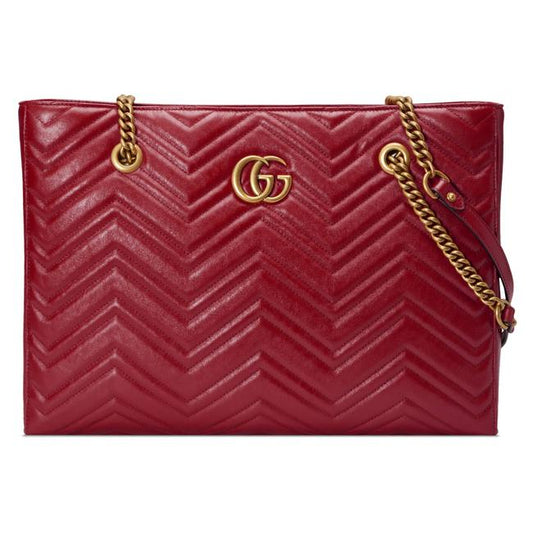 The Gucci GG Marmont Matelassé Leather Shoulder Bag in Red is a gorgeous leather bag with a tote silhouette which is accented by antique gold-tone hardware. Exquisite matelasse stitching accentuates the streamlined silhouette of a trim tote bag branded with antiqued double-G hardware inspired by an archival design.
