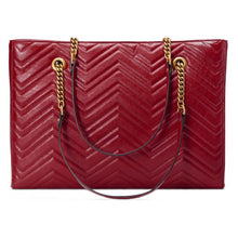 Load image into Gallery viewer, The Gucci GG Marmont Matelassé Leather Shoulder Bag in Red is a gorgeous leather bag with a tote silhouette which is accented by antique gold-tone hardware. Exquisite matelasse stitching accentuates the streamlined silhouette of a trim tote bag branded with antiqued double-G hardware inspired by an archival design.