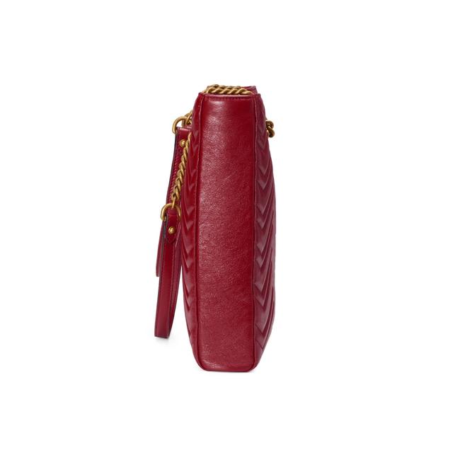 The Gucci GG Marmont Matelassé Leather Shoulder Bag in Red is a gorgeous leather bag with a tote silhouette which is accented by antique gold-tone hardware. Exquisite matelasse stitching accentuates the streamlined silhouette of a trim tote bag branded with antiqued double-G hardware inspired by an archival design.