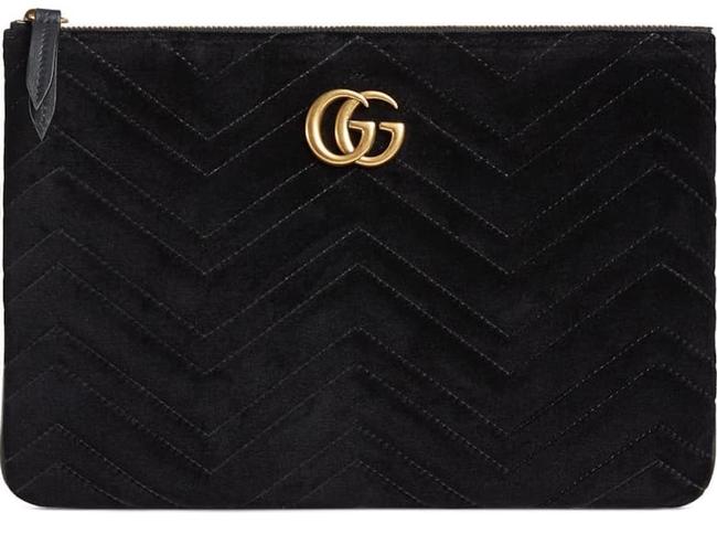 The Gucci Marmont Matelesse Velvet Zip Pouch is plush velvet textured with exquisite matelasse stitching enhances the statement-making style of a trim zip-top pouch that can double as a chic clutch. Gilded double-G hardware inspired by an archival design adds a signature finishing touch.