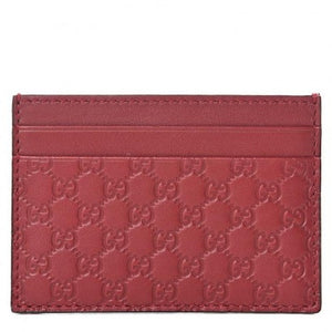 Gucci card holder.  Six card slots and a middle slot.  Bright Red color makes this card holder easy to find in a side pocket.  It is slim enough to carry in a back pocket.  Carry all of your essentials in style.