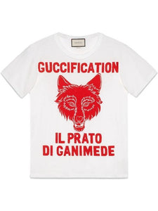 Gucci oversized T shirt in soft white cotten with a red printed fox face and the words "Guccification il prato di ganimede" printed above and below the wolf head.  This t shirt is striking and the print is very large.  The extra small size fits more like a medium sized t shirt would.  This t shirt is considered unisex by us but is part of the women's collection by Gucci.