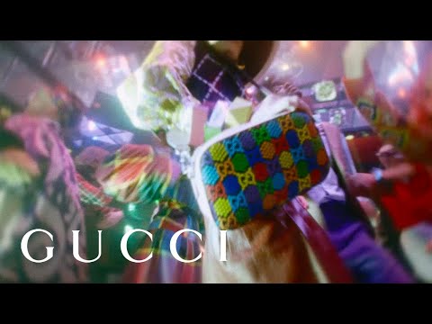 Gucci Psychedelic Supreme collection promotional video shows models dressed in the multi colored patterns of Gucci shoes, pant, shirts, dresses, bags, and more.  Gucci models are dancing in a disco setting with flashing lights, upbeat music and different camera angles.