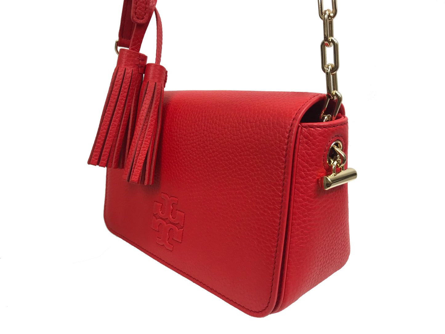 Imported Pebbled leather with removable tassels. Flap top with magnetic snap closure with stitch T-logo detail. Adjustable leather strap for shoulder/crossbody wear, 21" drop and detachable strap as well for use as clutch. Interior: Logo lining; one multifunction slip pocket. Approximate measurements: 8" L x 5-1/2" L x 3-1/4" W.
