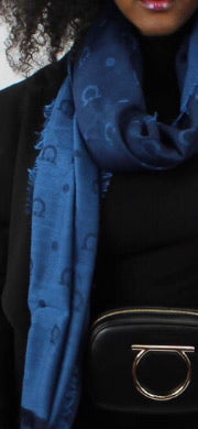 Keep warm and stay looking stylish in this scarf good for the winter or even as a shawl in warmer months.  Denim blue shades make it perfect for folding inside your bag to wear with jeans or something dressy.  Perfect for those air conditioned indoors and cool spring and summer nights.  Gancini Blue Libellula 60% Virgin wool, 28% Cashmere, 12% Silk 80
