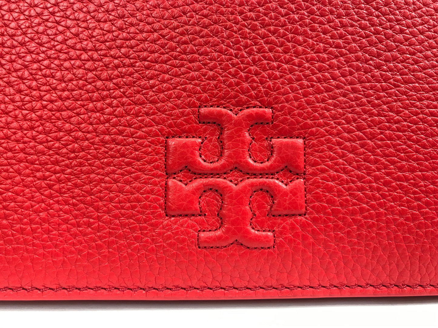 Imported Pebbled leather with removable tassels. Flap top with magnetic snap closure with stitch T-logo detail. Adjustable leather strap for shoulder/crossbody wear, 21" drop and detachable strap as well for use as clutch. Interior: Logo lining; one multifunction slip pocket. Approximate measurements: 8" L x 5-1/2" L x 3-1/4" W.