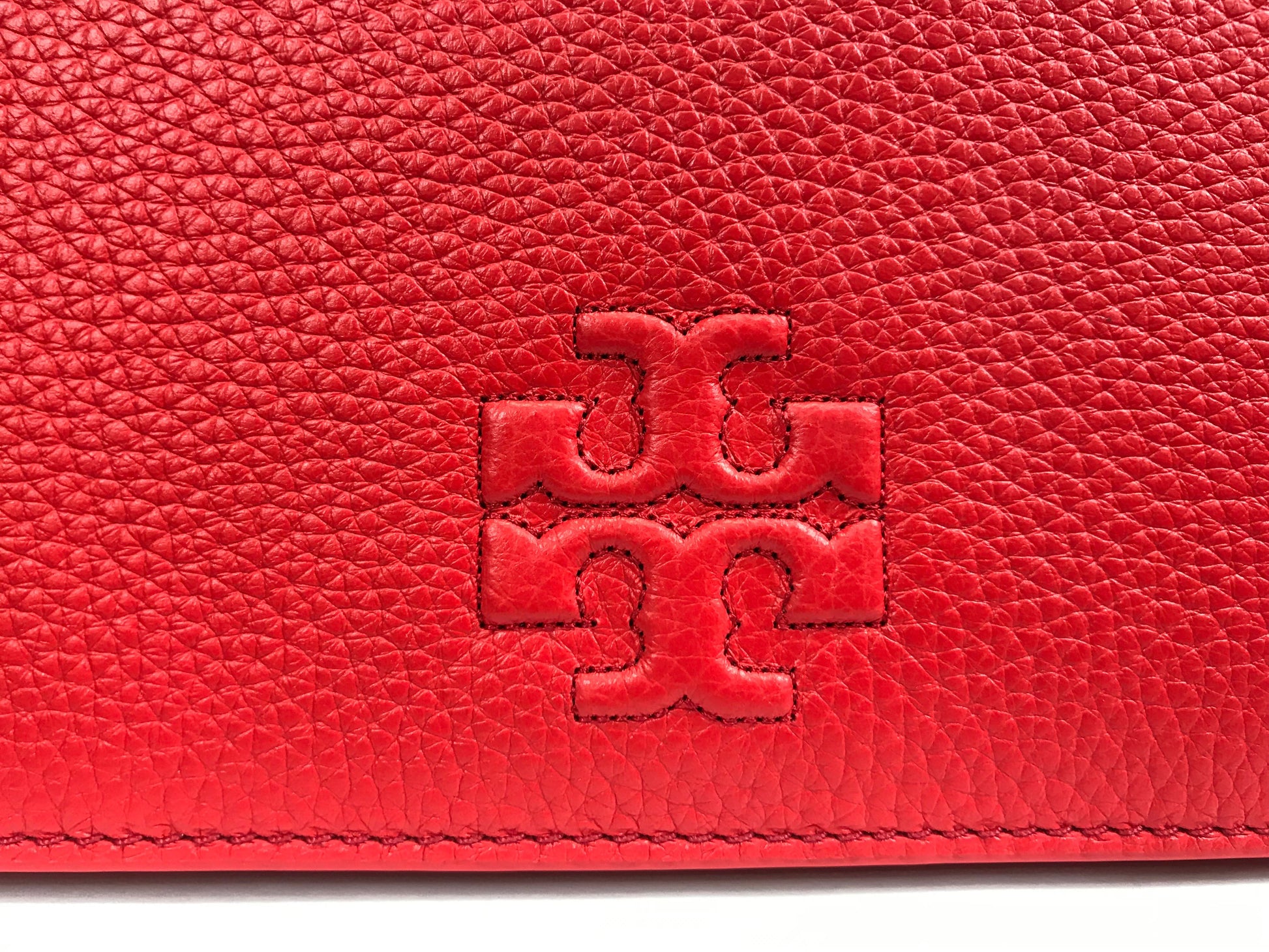 Imported Pebbled leather with removable tassels. Flap top with magnetic snap closure with stitch T-logo detail. Adjustable leather strap for shoulder/crossbody wear, 21" drop and detachable strap as well for use as clutch. Interior: Logo lining; one multifunction slip pocket. Approximate measurements: 8" L x 5-1/2" L x 3-1/4" W.