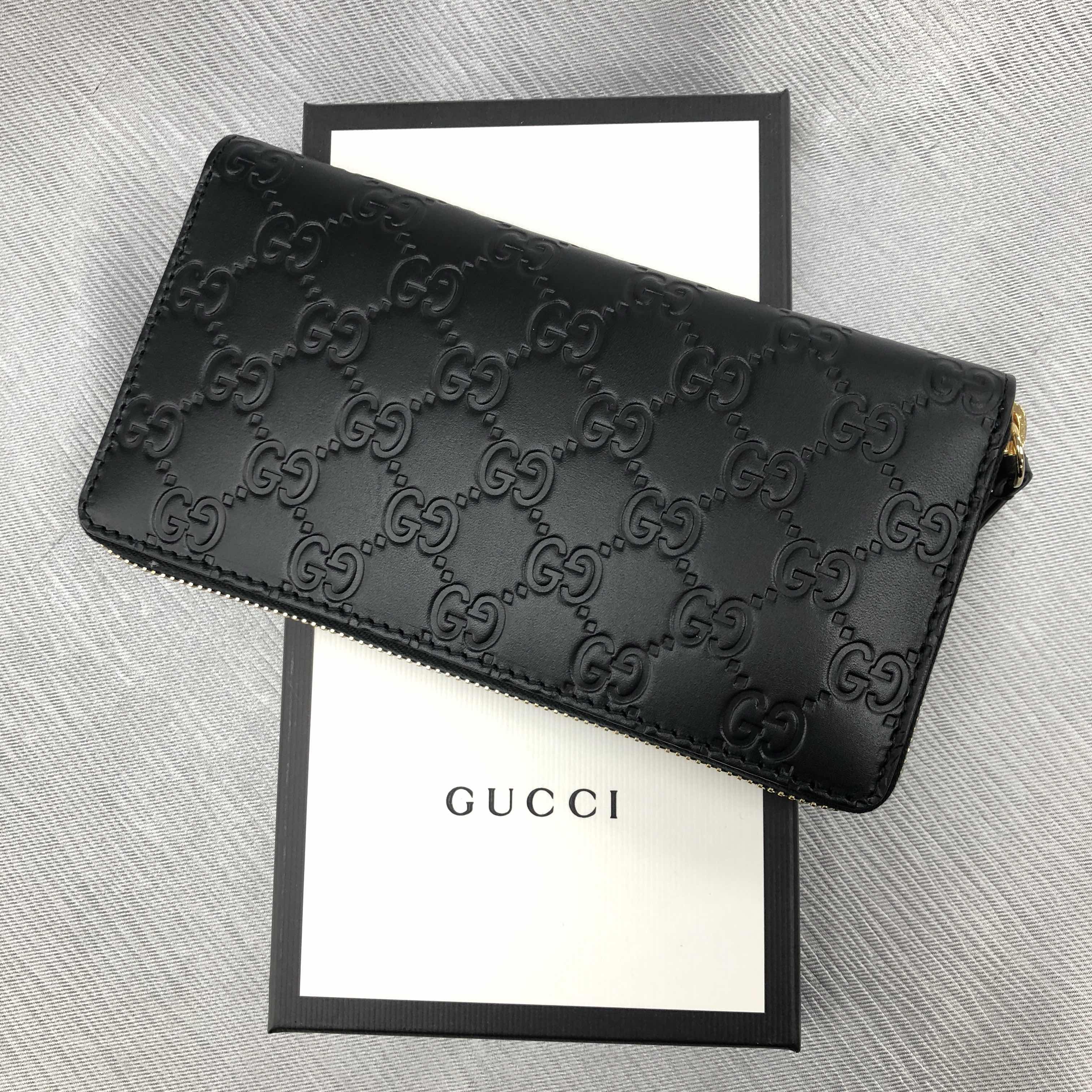 Gucci Interlocking GG Embossed Leather Zip Around Wallet in Black
